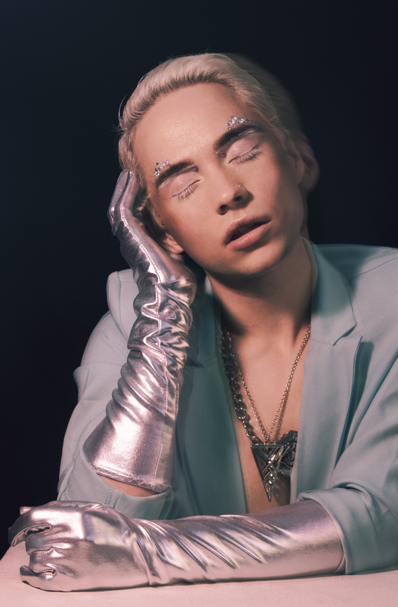 Charlie Void in an ice-blue blazer and silver opera gloves