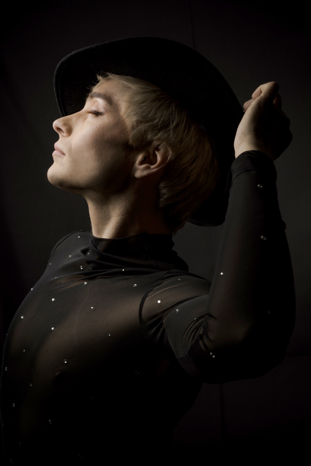 Profile portrait of Charlie Void in a wide-brimmed black hat