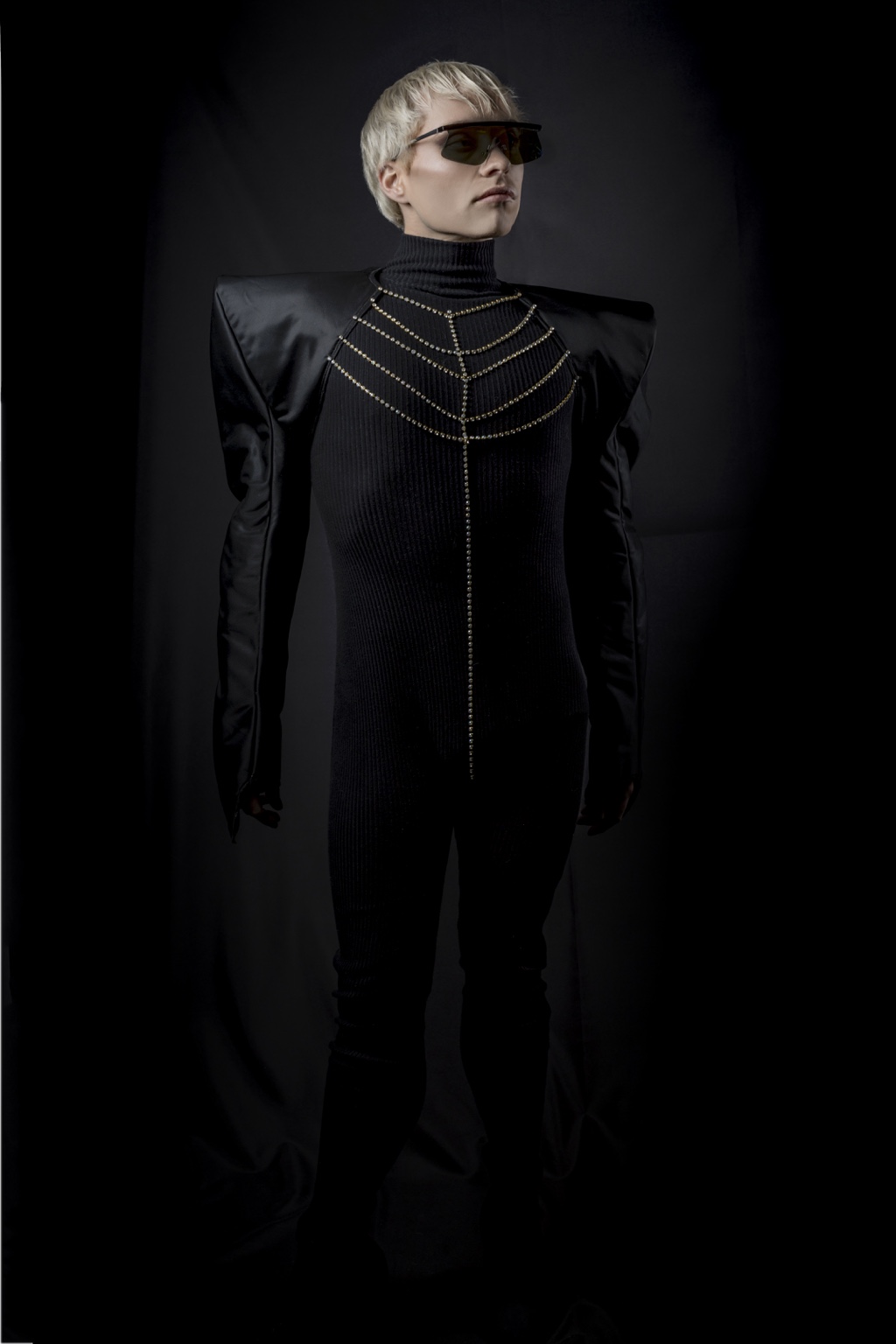 Full architectural silhouette of Charlie Void in black sculptural tailoring