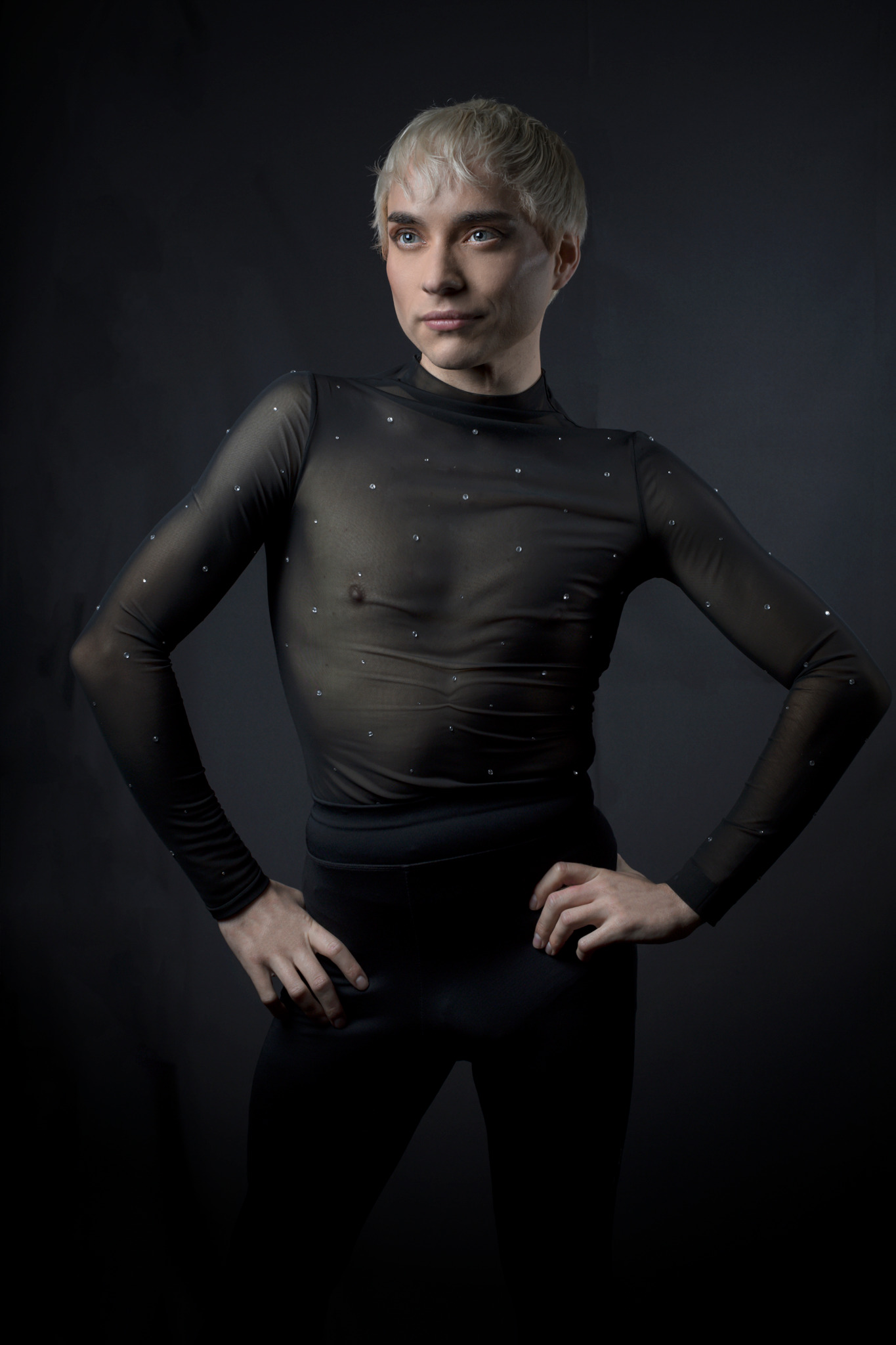Clean full-body press portrait of Charlie Void in a restrained black performance look